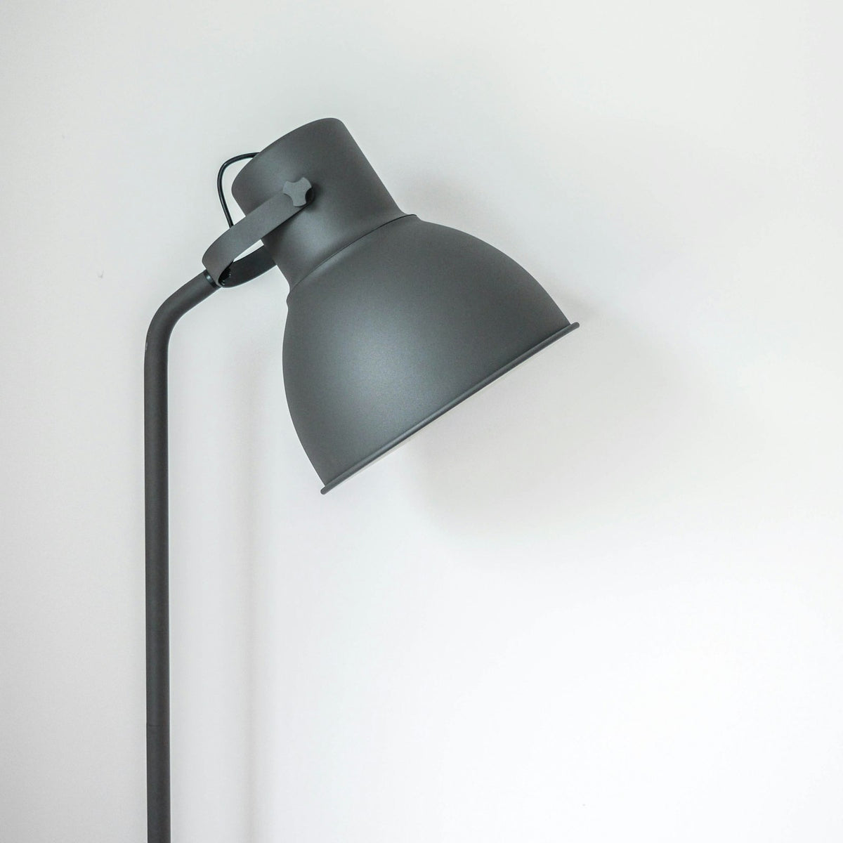 Grey metal floor lamp with an adjustable dome shade
